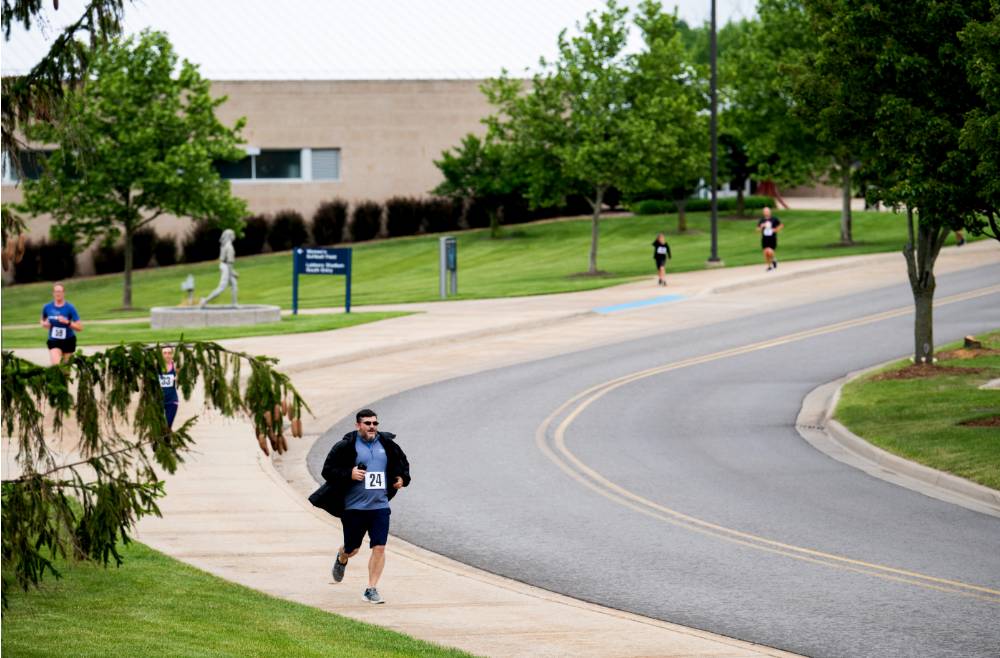 Brent Holmes running near the Kelly Sports Building on campus